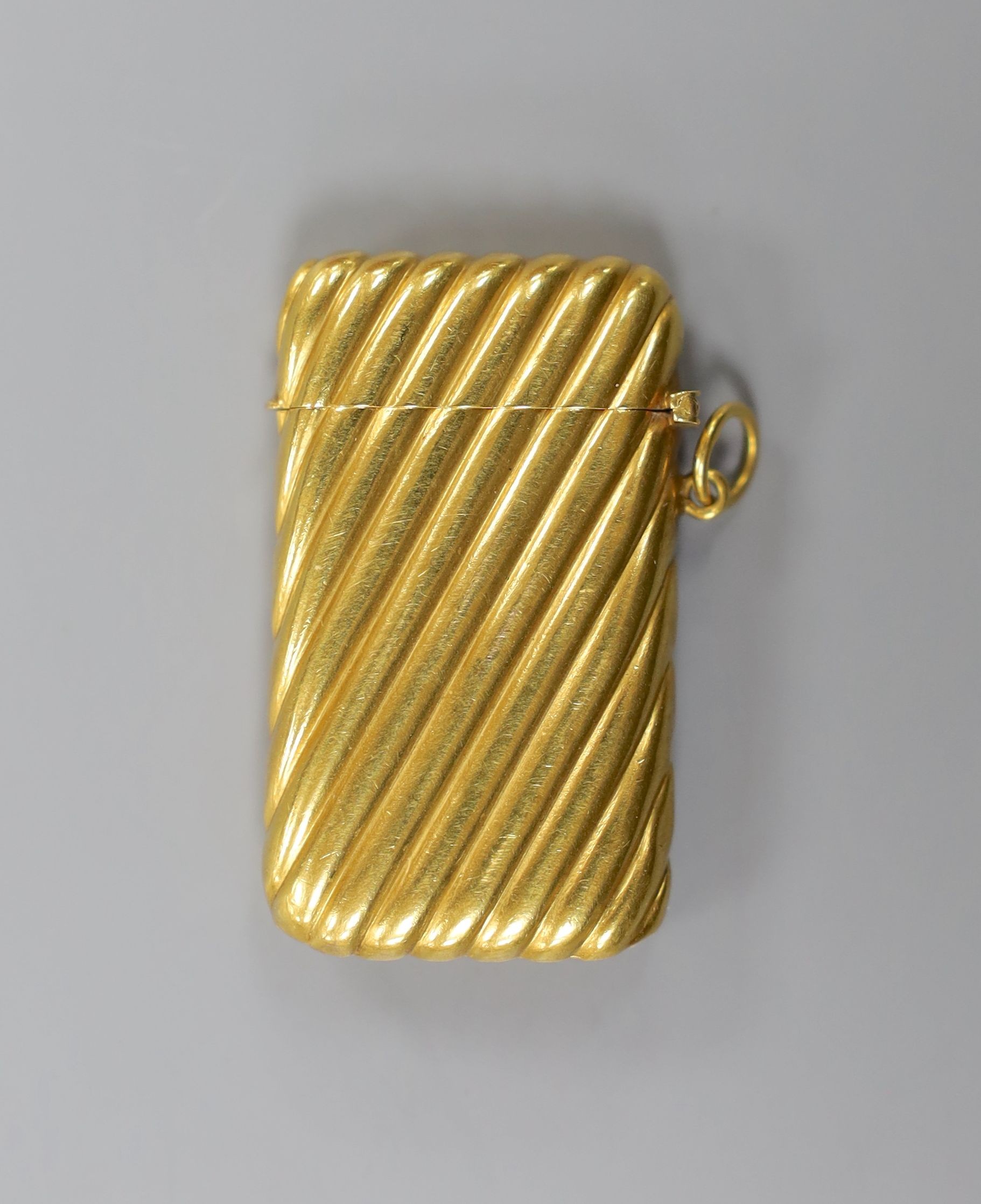 An early 20th century French fluted yellow metal (18ct poincon mark) vesta case, 45mm,gross 13.5 grams.